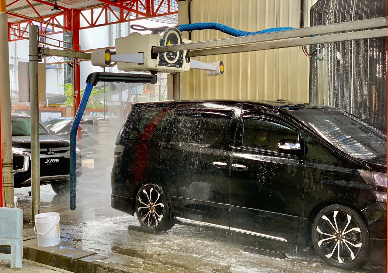 An MPV in the automatic wash bay at SJ Auto Car Wash
