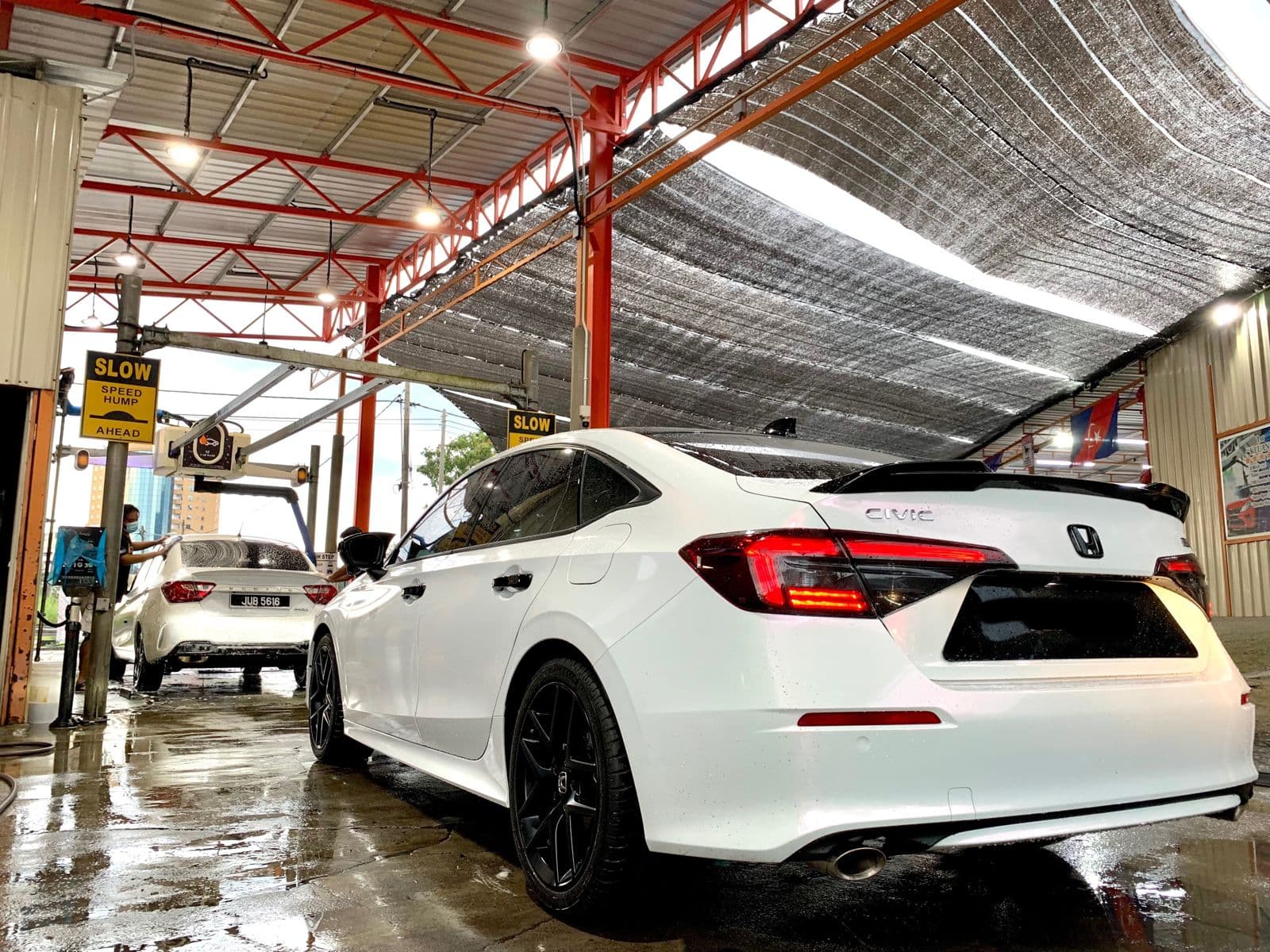 A sedan in the wash area at SJ Auto Car Wash