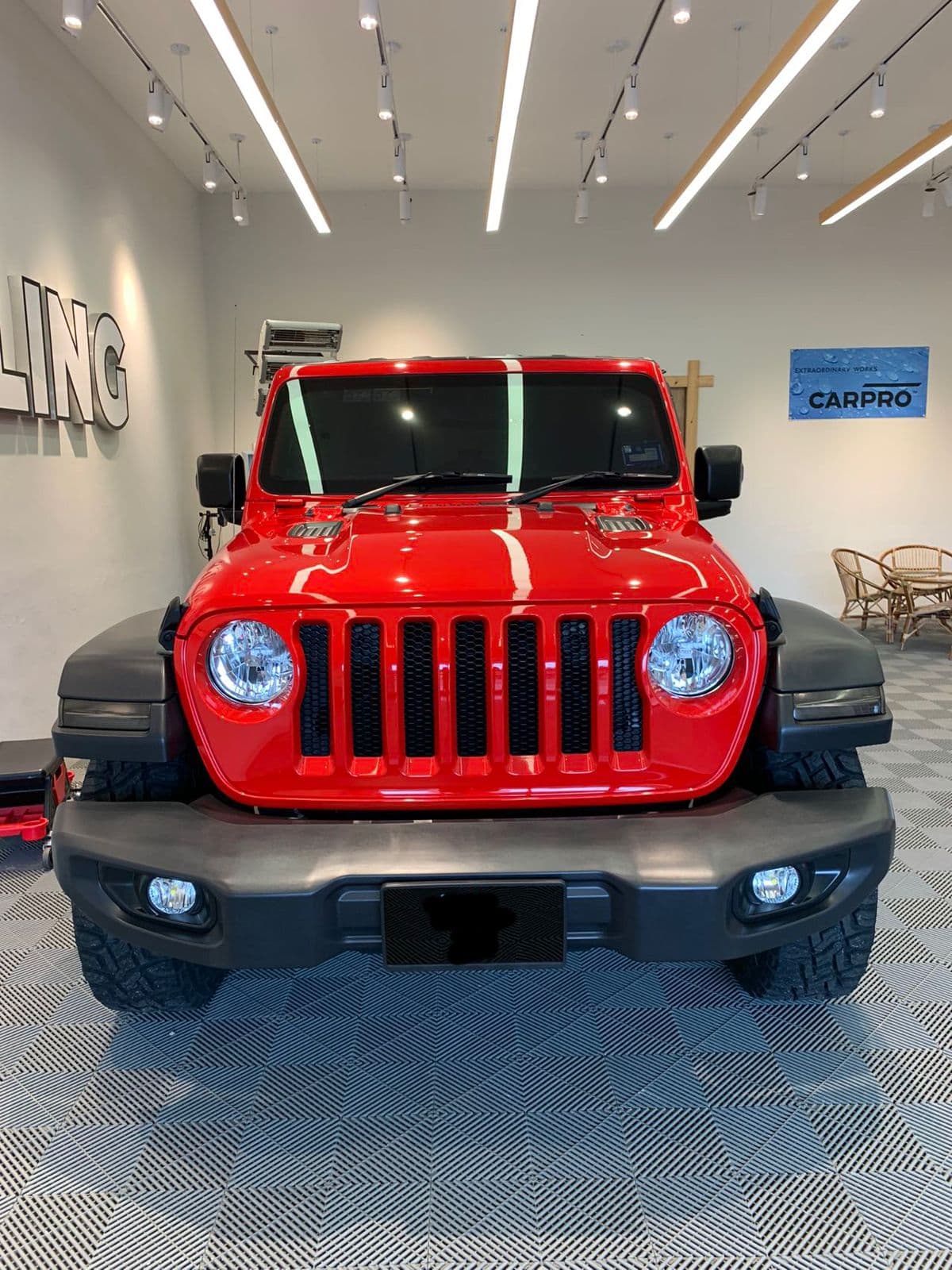 A red 4x4 in the SJ Auto Detailing showroom