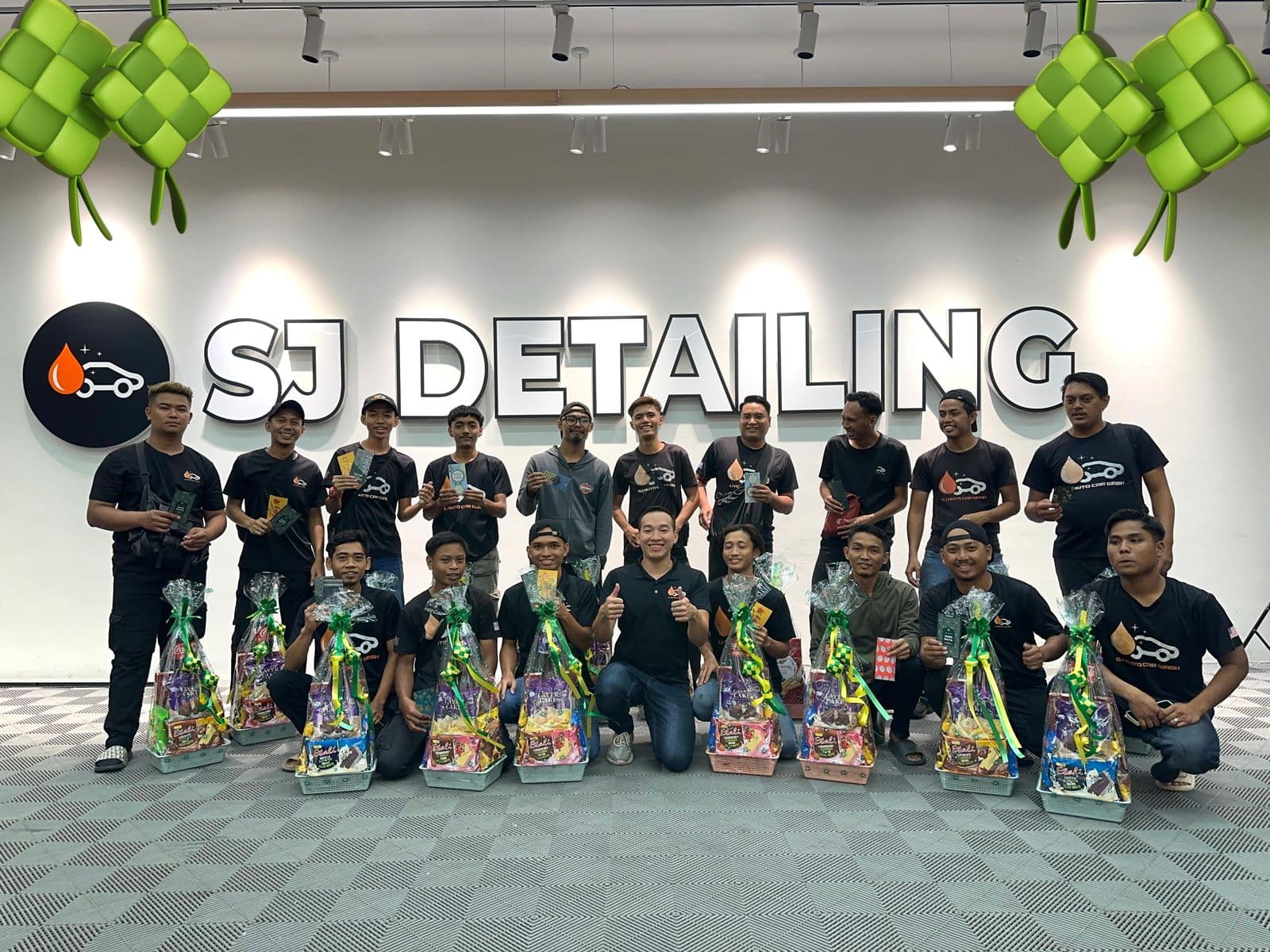 The SJ Auto Detailing team inside the Kluang showroom