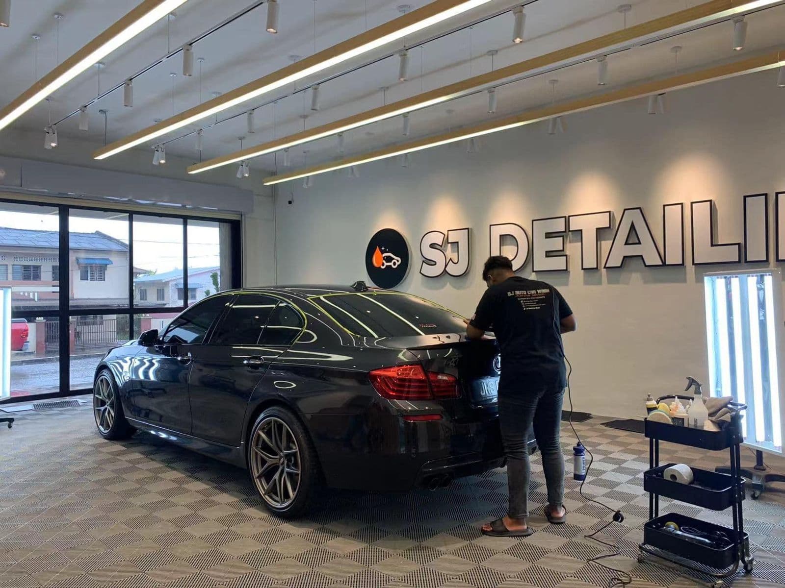 Staff working on a car's paint at SJ Auto Detailing